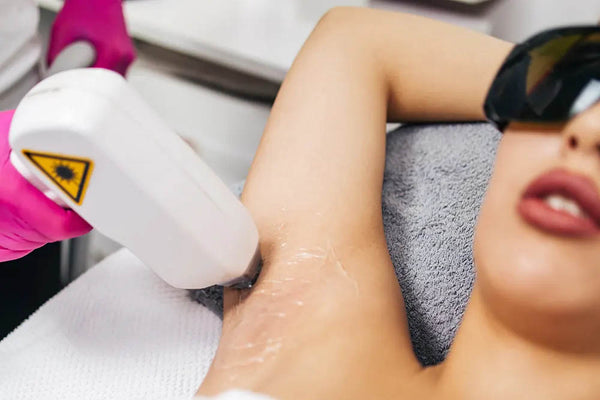Woman doing underarms laser hair removal