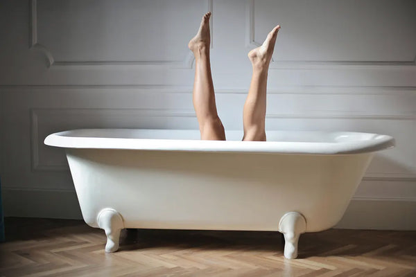 Woman removes leg hair after bath